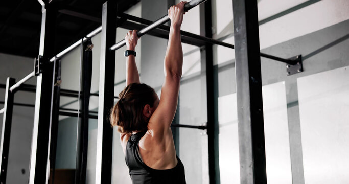 Strong Young Woman Doing Pull Up Workout
