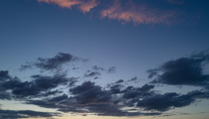 Sunset or sunrise. Dramatic majestic scenery sunset. Sky with clouds in sunset sky light background. Sunrise with clouds in various shapes. Calm sunset sky and sun through clouds over.