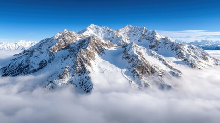 Layered mountain peaks partially hidden by soft clouds and dense fog, evoking a sense of peace and grandeur amidst the natural wilderness