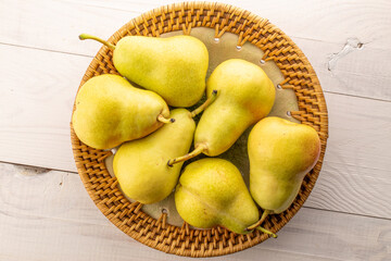 Juicy yellow pears on a wooden table, top view, macro.