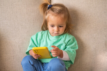 Sweet Toddler Exploring Smartphone Safely, Showing Authentic Curiosity About Technology And Modern Learning