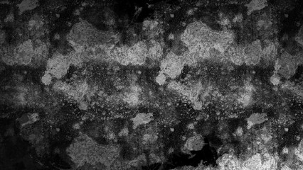 Black and white speckled surface with scattered patches.