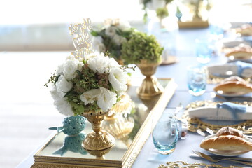 Elegant Long Table Setting with Blue Tablecloth and Gold Accents