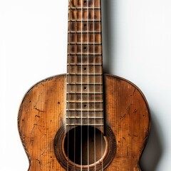 Obraz premium Old acoustic guitar with a weathered and distressed finish is leaning against a white wall