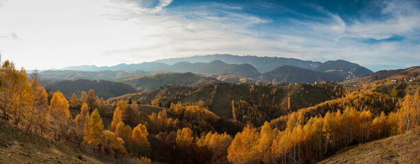 Panoramic overview of Magura village in Romania, near the Piatra Craiului mountains, at sunset