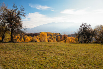 Fototapeta premium Scenic autumn overview of Magura village in Romania, near the Piatra Craiului mountains
