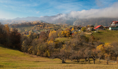 Scenic autumn overview of Magura village in Romania, near the Piatra Craiului mountains