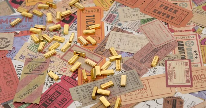 Sibiu, Romania - November 09, 2024. gold bars on vintage tickets from around the world, theater, movie, concerts, transport, boarding passes, hotel reception cards and other documents