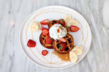 A waffle is a dish made from leavened batter or dough that is cooked between two plates that are patterned to give a characteristic size, shape, and surface impression.