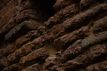Closeup of a textured brown stone wall, highlighting unique details and its complexity