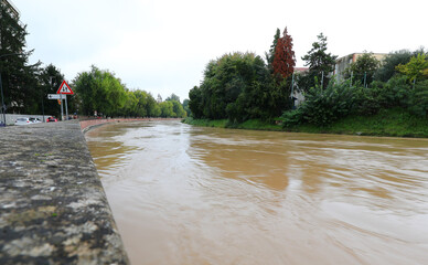 brown  river almost at flood level due to torrential rain
