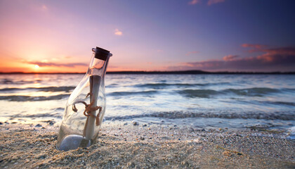 romantic sunset at the beach with bottle with a message, beautiful message in a bottle
