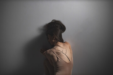 Dancer Posed with Elegant Tattoo, Reflective Mood
