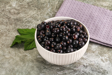 Ripe black currant in the bowl