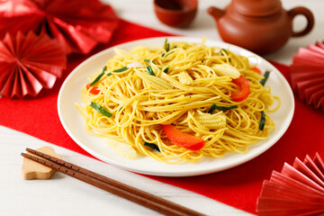 Chinese Lunar New Year concept with lucky food longevity noodles on wooden table background.