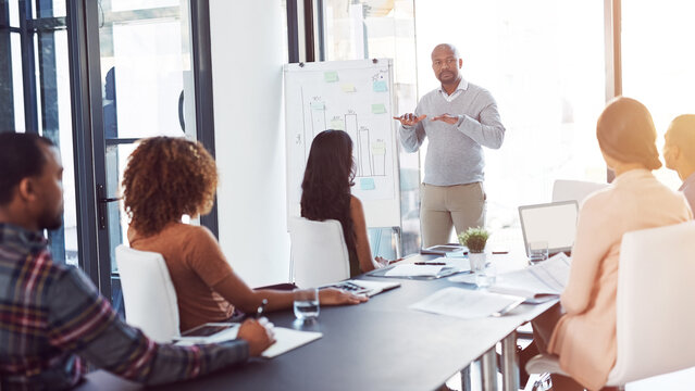 Creative, meeting and man at whiteboard for presentation, planning or internship training at agency. Office, discussion and business people in conference room for teamwork, strategy ideas or proposal