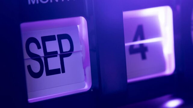Timelapse of flip calendar clock in 1 year in purple light