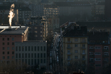 Dark city, jet of steam from chimney