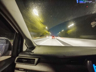 Obraz premium Viewing the night journey from the front passenger seat of a car