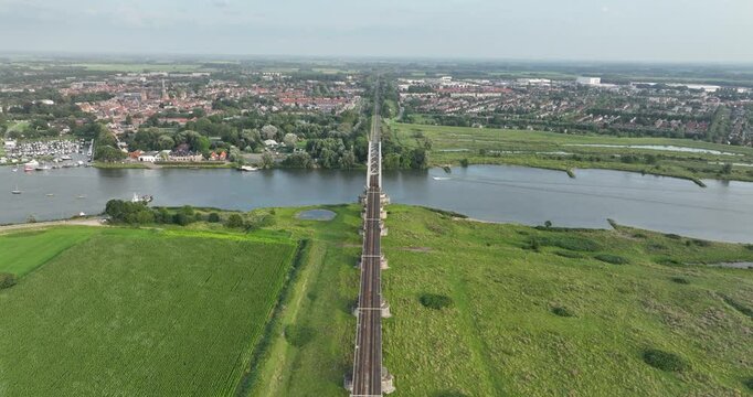 Aerial drone video of rail road bridge over the Lek river at Culemborg, Gelderland, The Netherlands.