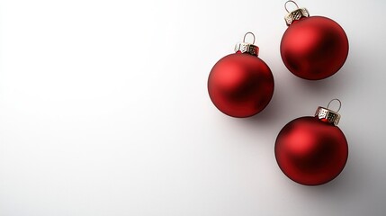 Three red Christmas ornaments resting on a white surface, creating a festive and elegant holiday atmosphere.