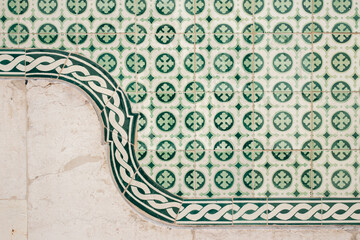 Decorated floral green traditional azulejo ceramic tiles on a wall in Lisbon, Portugal.