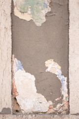 The texture of peeling paint and plaster on a wall in Lisbon, Portugal