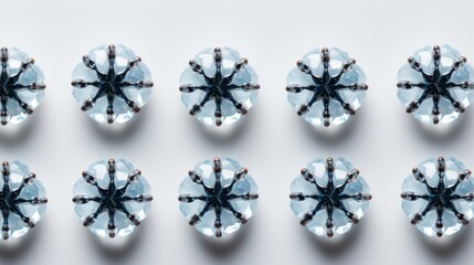 A symmetrical arrangement of blue, star-shaped, faceted crystal buttons with metallic details on a white background