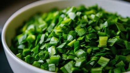 Close-up of chopped yard-long beans in a white bowl, ready for cooking, with a vibrant green color against a neutral background.