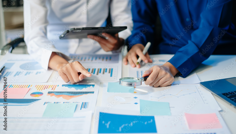 Poster business documents on office table with smart phone and calculator digital tablet and graph business
