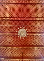 Thai temple red golden ceiling interior Chandelier with hand drawing pattern most exquisite beauty meticulous craftsmanship stunningly beautiful.