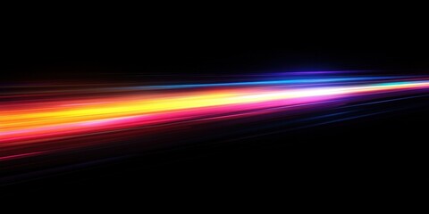 Abstract light streaks in vibrant colors on a black background, showcasing energy and movement, perfect for backgrounds or design projects emphasizing speed and dynamism.
