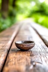 A small wooden bowl sitting on top of a wooden table