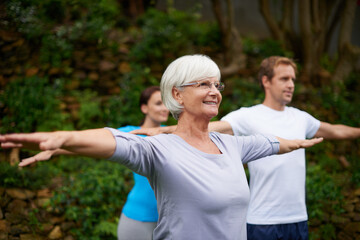 Obraz premium Park, senior or woman in yoga class for stretching arms, balance or inner peace in nature. Group meditation, smile or happy elderly person with people for spiritual healing, energy or mindfulness