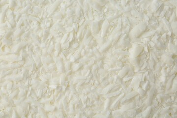 White soy wax flakes as background, closeup