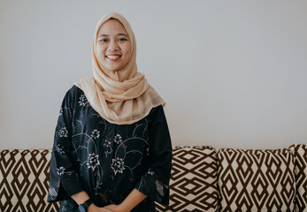 Close up portrait of beautiful asian hijab woman smiling looking at camera.