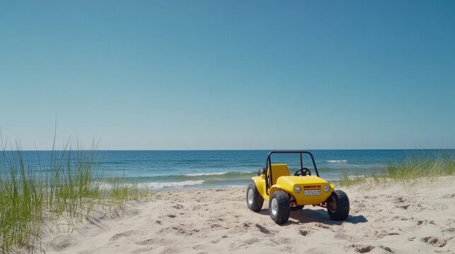 A vibrant yellow dune buggy drifts across sandy beach dunes under bright midday sunlight by the ocean