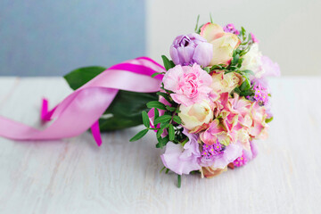 Fresh, spring wedding bouquet made with peonies and pink ribbons