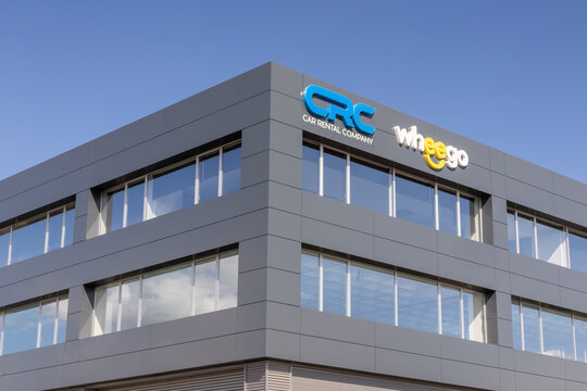 Wheego and crc car rental company signs on modern building
