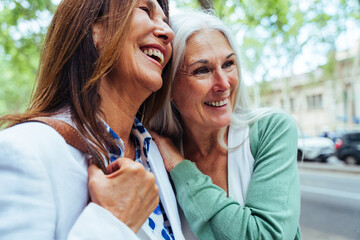 Beautiful senior women bonding outdoors in the city - Attractive cheerful mature female friends...