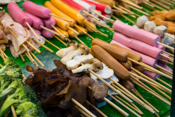 Various meatball skewers and vegetables skewers for shabu, grilled, steamed in the Thai market.
