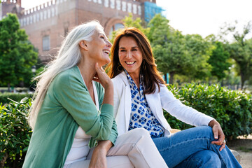Beautiful senior women bonding outdoors in the city - Attractive cheerful mature female friends...