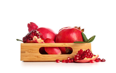 Wooden tray with fresh ripe pomegranates and leaves on white background
