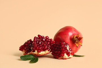 Fresh ripe pomegranates and leaves on yellow background