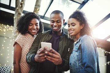 Cellphone, happy and group of friends online reading blog on website for celebrity gossip together. Smile, networking and young people with phone for browsing on technology social media app at party.