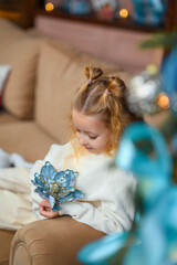 happy beautiful little girl in living room near decorated Christmas tree. christmas and new year concept