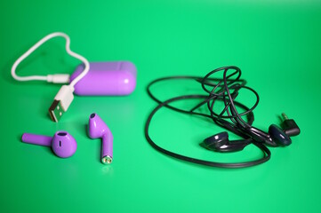 Wireless headphones next to wired headphones.