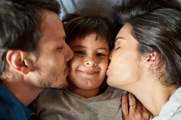 Parent, kid and happy in home with kiss for playing with support, care and love. People, family and smile with boy or son at apartment for bonding, break and relax with child development and growth