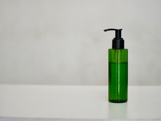 green skincare bottle with liquid