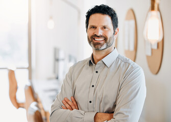 Obraz premium Happy, crossed arms and portrait of business man in office with confidence, company pride and ambition. Professional, corporate and person in workplace with smile for career, job and opportunity